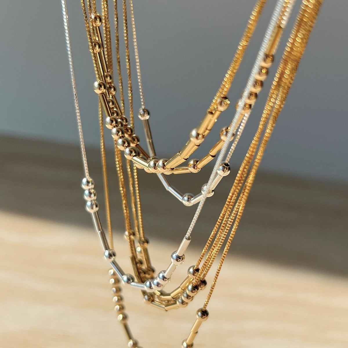 Morse code necklaces hanging in different tones