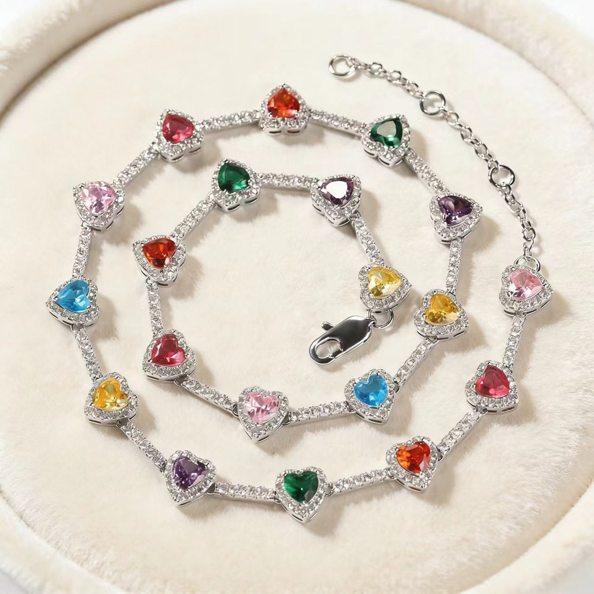 Silver Rainbow Heart Necklace on a jewelry stand
