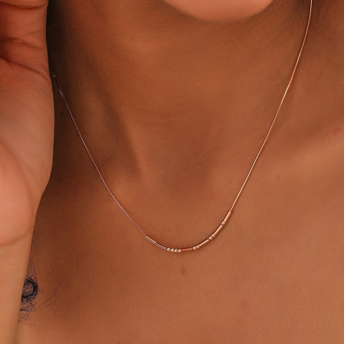 Rose gold Morse code necklace worn